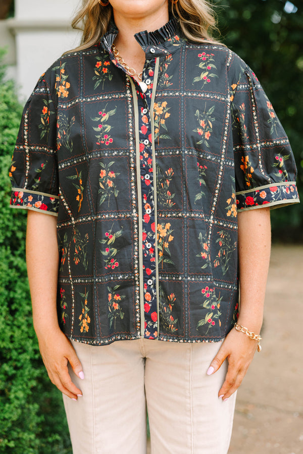 Plus size black cotton button-up top with multi-floral print, puff sleeves, and ruffled collar.