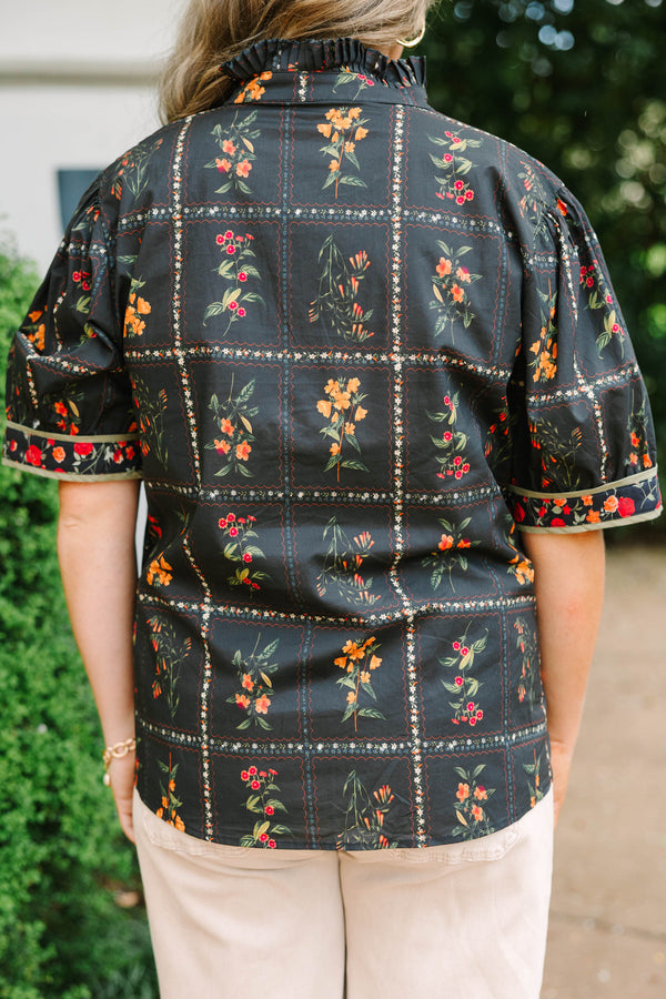 Plus size black cotton button-up top with multi-floral print, puff sleeves, and ruffled collar.