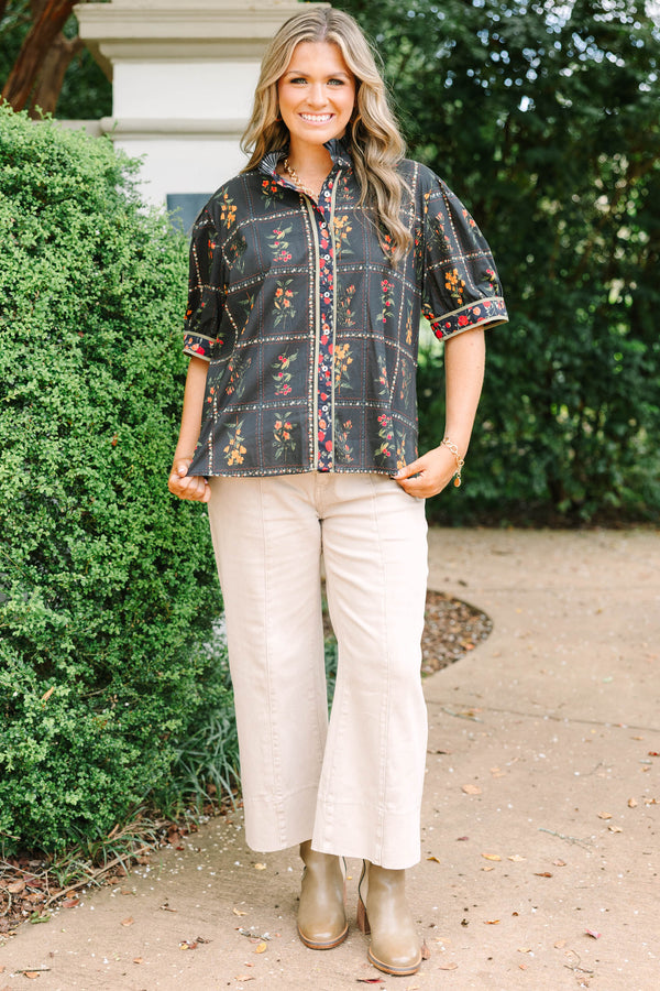 Plus size black cotton button-up top with multi-floral print, puff sleeves, and ruffled collar.