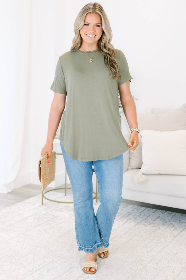 Plus size olive green top with a flowy fit and short sleeves.