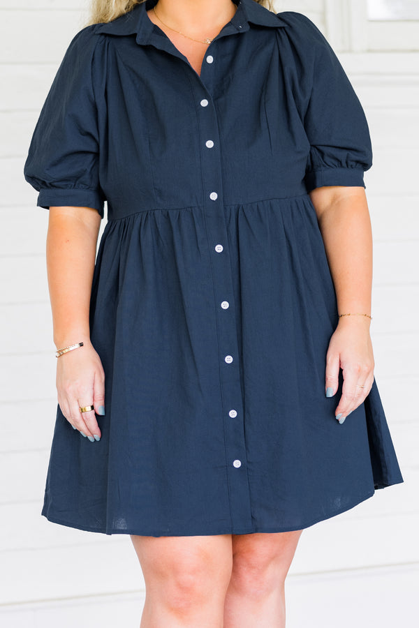 Plus Size navy blue babydoll dress with short puff sleeves, a collared neckline, and button front.