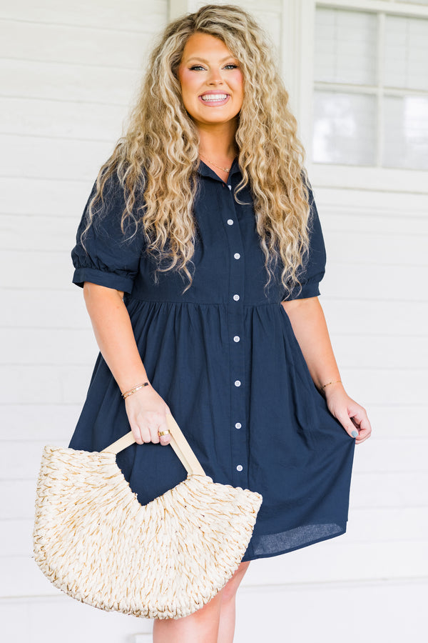 Plus Size navy blue babydoll dress with short puff sleeves, a collared neckline, and button front.