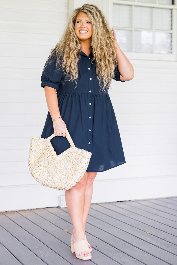 Plus Size navy blue babydoll dress with short puff sleeves, a collared neckline, and button front.