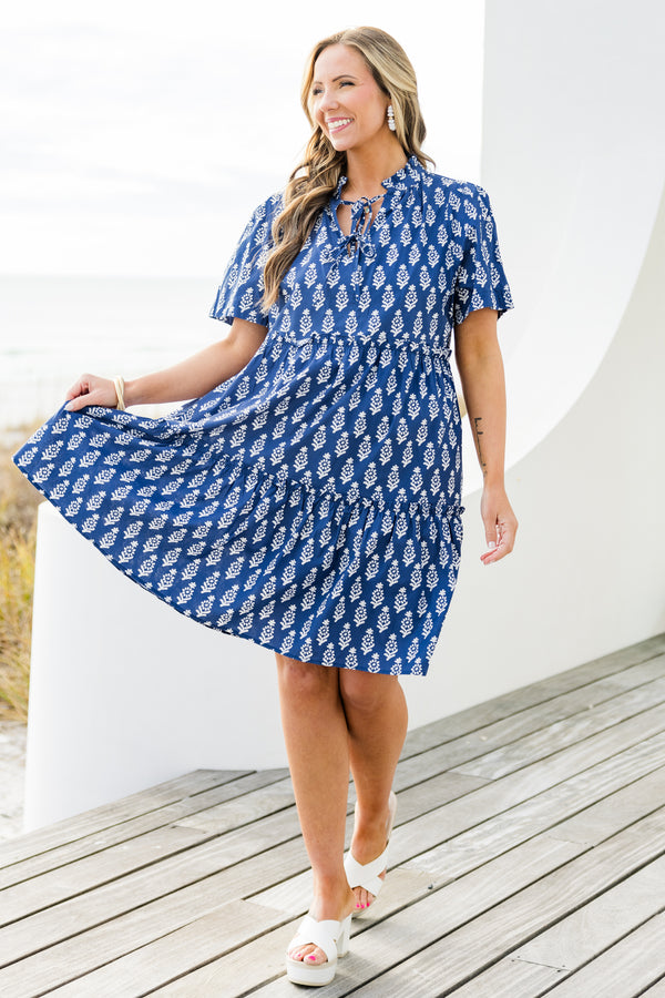Chic Soul plus size clothing, navy short sleeve mini tiered dress with v cutout along neckline with tie detail with ruffle neckline with white eyelet design with ruffles along tiers