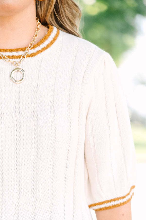 Plus size woman in oatmeal ribbed knit top with mustard stripes