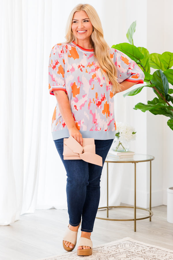 Chic Soul plus size clothing, short-sleeve puffed sleeve knit powder blue top with orange and pink camo pattern and lined pattern on sleeves and neckline 