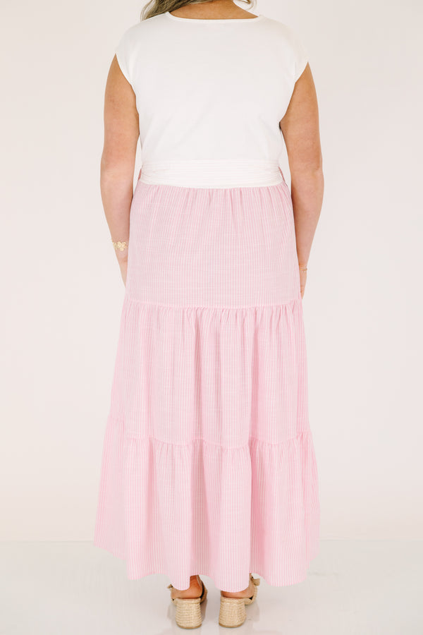 Plus Size maxi dress with a white short-sleeve bodice and a tiered pink striped skirt with a bow.