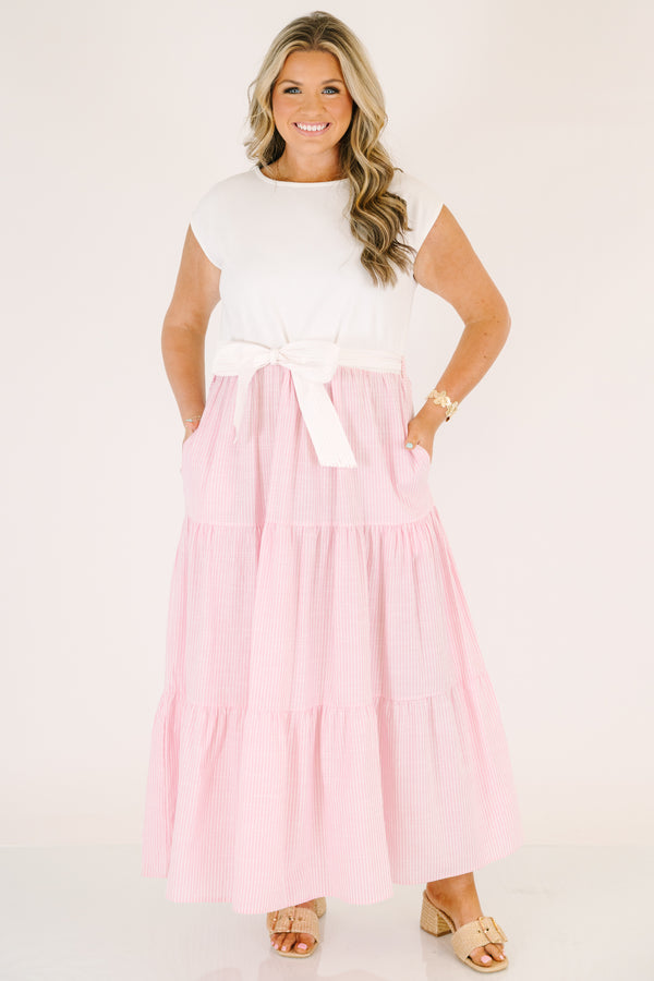 Plus Size maxi dress with a white short-sleeve bodice and a tiered pink striped skirt with a bow.