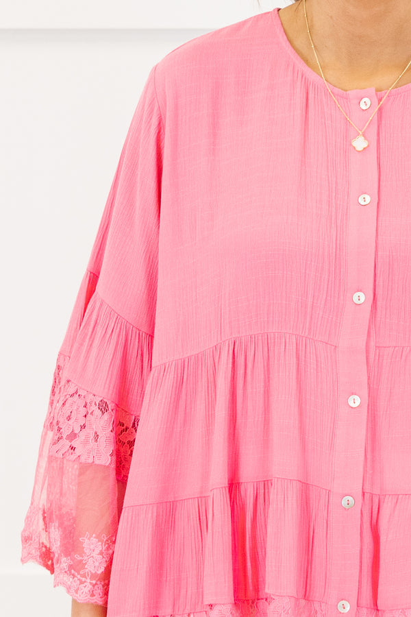 Chic Soul plus size clothing, quarter-sleeve ruffled flowy hot pink blouse with a scoop-neckline and white button detailing along the front with subtle lace detailing on the ruffles of the top and the sleeves 