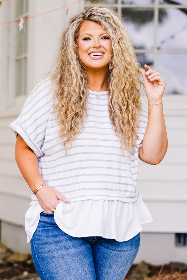 Plus Size blue and white striped babydoll top with short sleeves and a white ruffled hem.