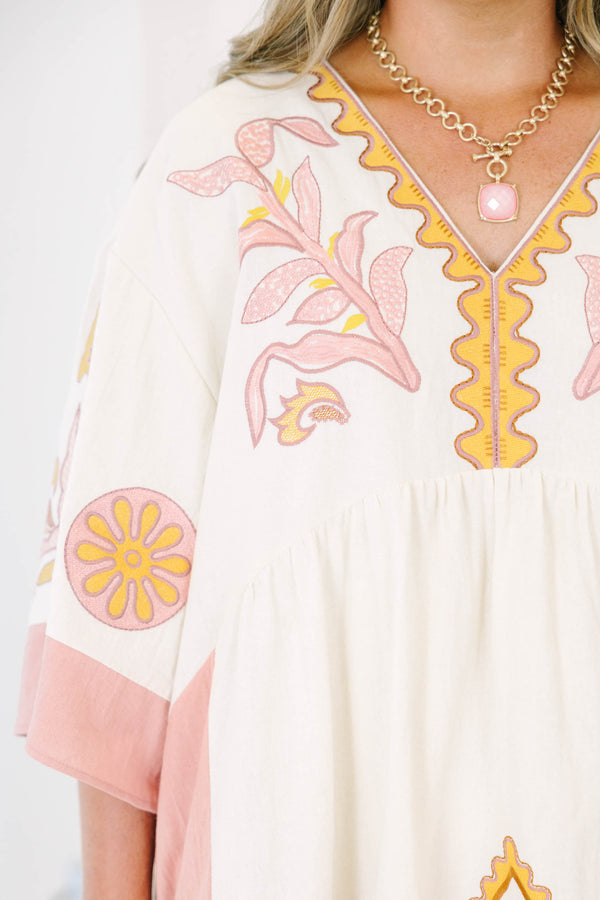 Plus Size light pink and cream V-neck dress with floral embroidery and wide sleeves.