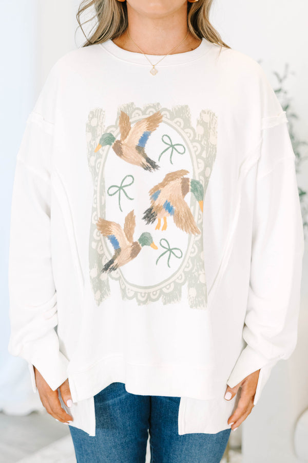 Plus size ivory crewneck sweatshirt with a vintage-style duck and bow graphic and a relaxed fit.