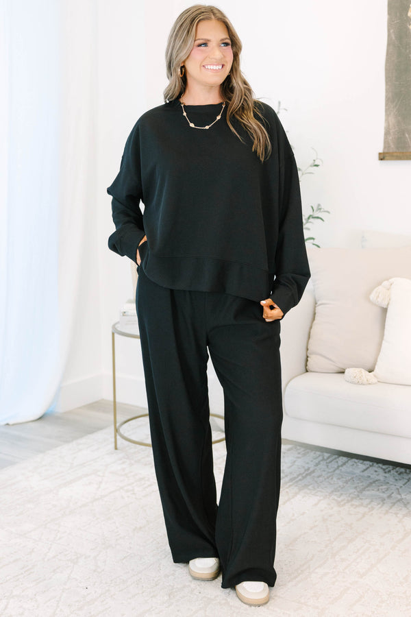 Plus Size black ribbed loungewear set featuring a long sleeve crewneck top and wide-leg pants.