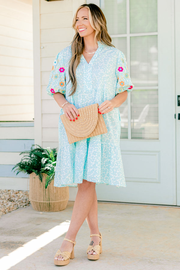 Chic Soul plus size clothing, Turquoise short sleeve dress with a white floral pattern as well as colorful embroidered flowers on the bubble sleeves 