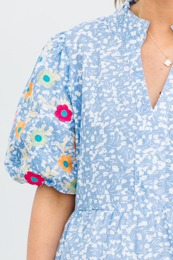 Plus Size blue ditsy floral dress with embroidered puff sleeves and a split v-neckline.