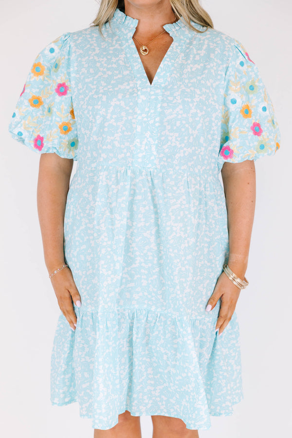 Chic Soul plus size clothing, Turquoise short sleeve dress with a white floral pattern as well as colorful embroidered flowers on the bubble sleeves 