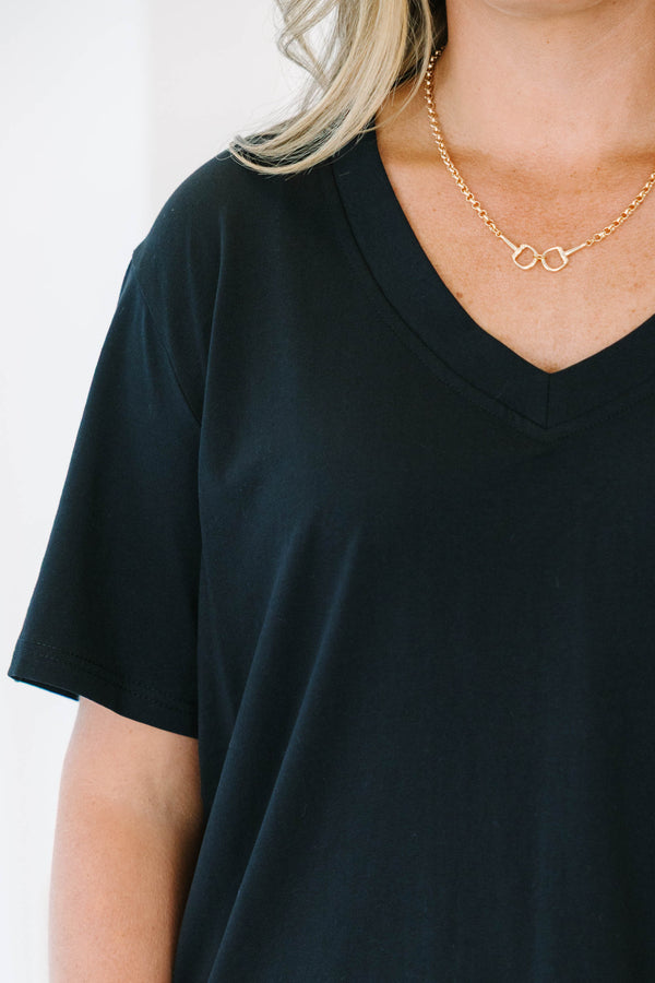 Plus Size black short sleeve V-neck t-shirt with a relaxed fit, paired with blue jeans.