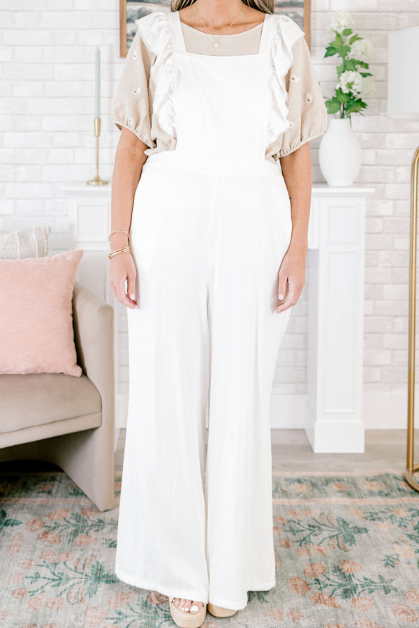 Plus Size white wide-leg jumpsuit with adjustable straps and frayed flutter sleeve details.
