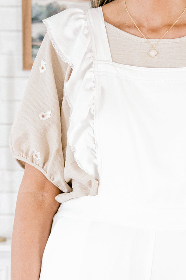 Plus Size white wide-leg jumpsuit with adjustable straps and frayed flutter sleeve details.