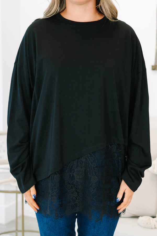Plus Size black long sleeve top with a crew neckline and an asymmetrical lace hem.
