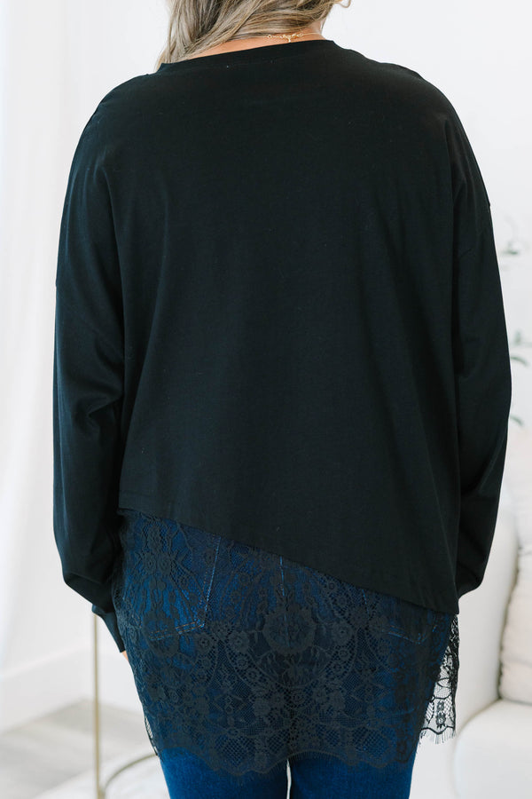 Plus Size black long sleeve top with a crew neckline and an asymmetrical lace hem.