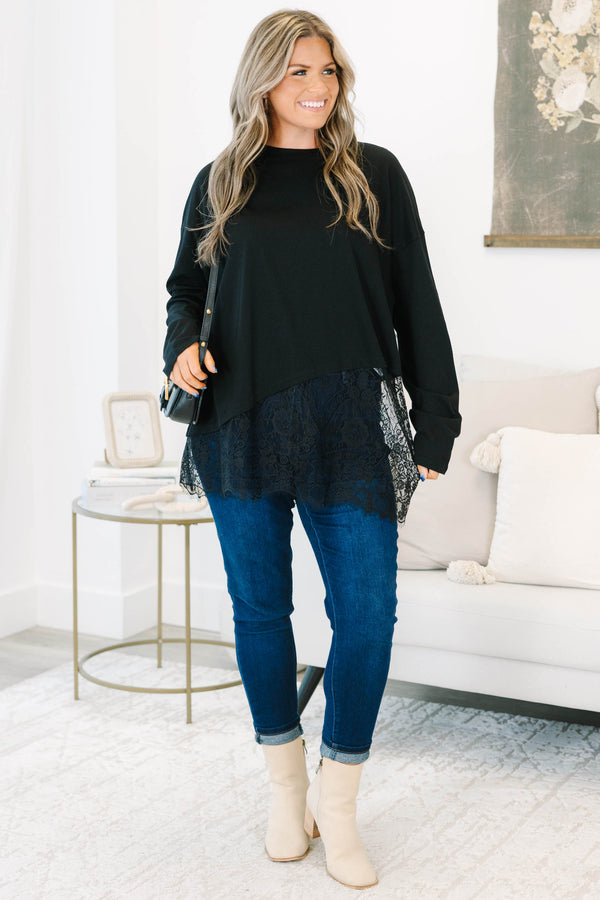 Plus Size black long sleeve top with a crew neckline and an asymmetrical lace hem.