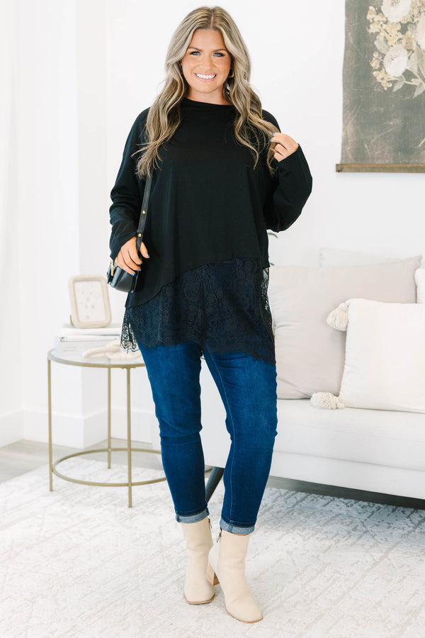 Plus Size black long sleeve top with a crew neckline and an asymmetrical lace hem.