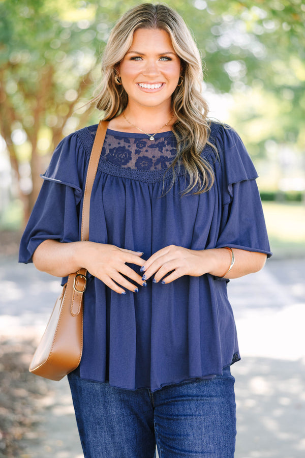 Plus Size navy top with lace floral yoke, ruffled short sleeves, and a flowy, pleated fit.