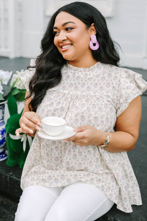 Chic Soul plus size clothing, cream top with flutter sleeves and a high neck that has ruffle detailing on the neckline of the top as well as a light floral pattern throughout the top 
