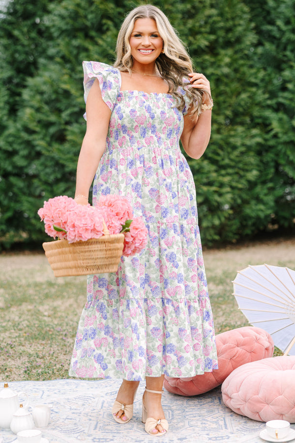 Chic Soul plus size clothing, pink and lilac tiered maxi dress with flutter sleeves as well as a smocked bust a square neckline and a hydrangea pattern throughout