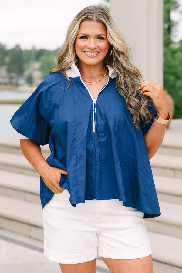 Plus size navy blue quarter-zip top with a flowy fit, white collar, and short puff sleeves.