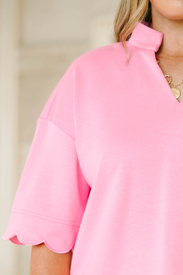 Plus size pink two-piece set with a scalloped hem top and matching shorts in a soft, stretchy knit.