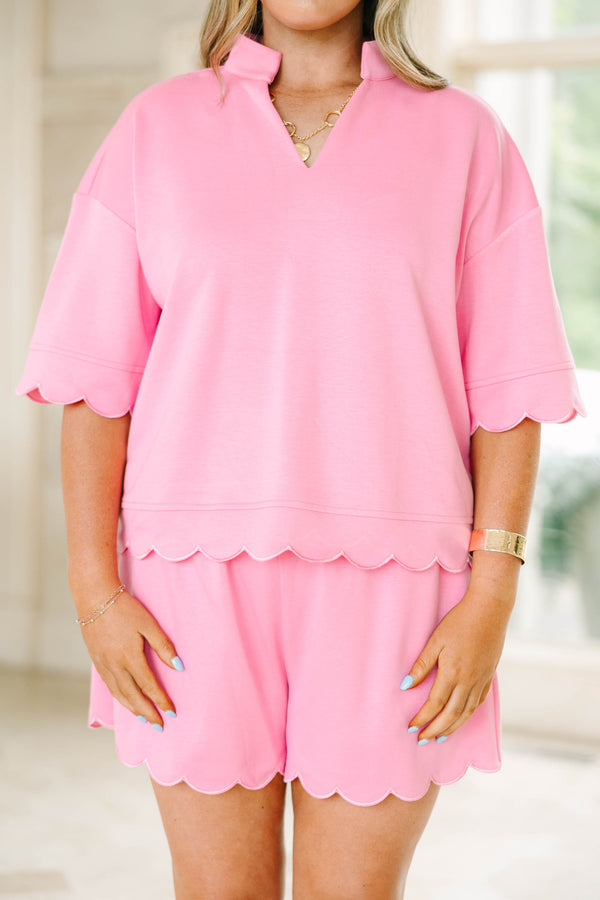 Plus size pink two-piece set with a scalloped hem top and matching shorts in a soft, stretchy knit.