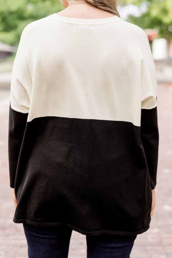 Plus Size ivory and black colorblock sweater with a crew neck, long sleeves, and front pockets.
