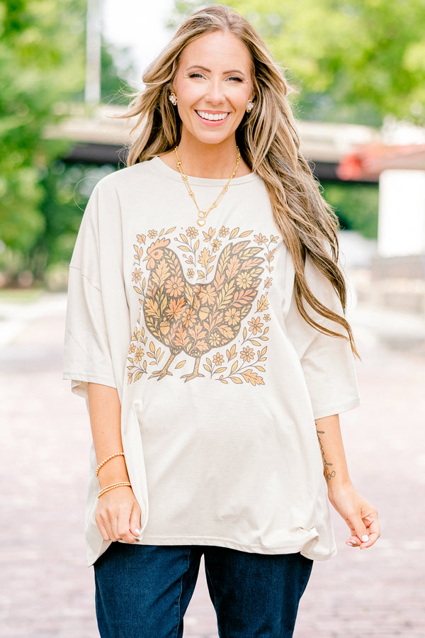 Chic Soul plus size clothing, dust colored short sleeve boyfriend tee with a turkey graphic on the center of the tee that is filled with a fall leaves pattern and also has leaves around the turkey 