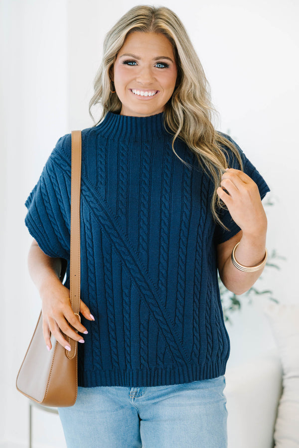 Plus size navy blue sleeveless cable-knit sweater with a mock neckline and diagonal seam detail.