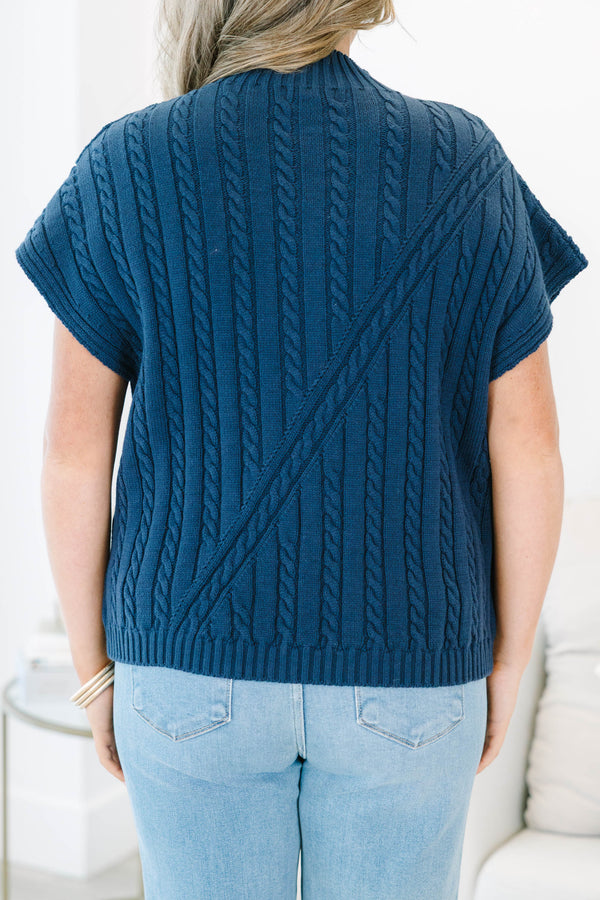 Plus size navy blue sleeveless cable-knit sweater with a mock neckline and diagonal seam detail.