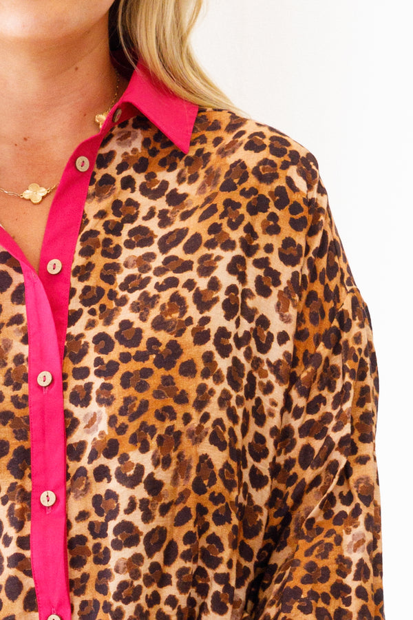 Chic Soul plus size clothing, leopard top with pink details at the end of each sleeve and going down the center of the blouse also ruffle details at the bottom of the top 