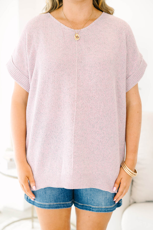Plus size woman in a pink and gray marled knit short sleeve sweater with a relaxed, flowy fit.