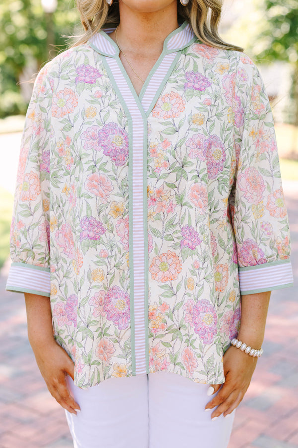 Plus size green floral V-neck top with striped trim and flowy 3/4 sleeves
