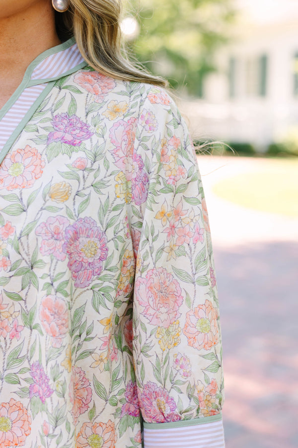 Plus size green floral V-neck top with striped trim and flowy 3/4 sleeves