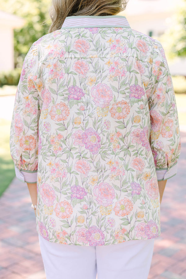Plus size green floral V-neck top with striped trim and flowy 3/4 sleeves