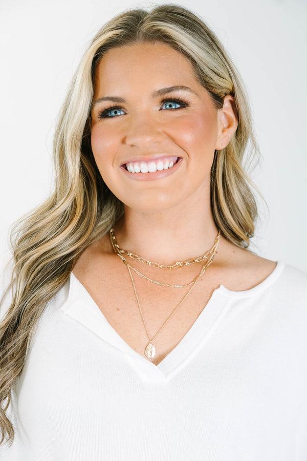 Gold layered necklace with a teardrop pendant.