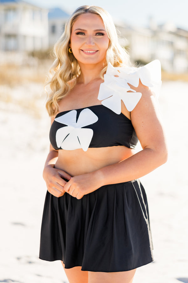 Plus Size black pleated swim skirt with a wide waistband and built-in bottoms.