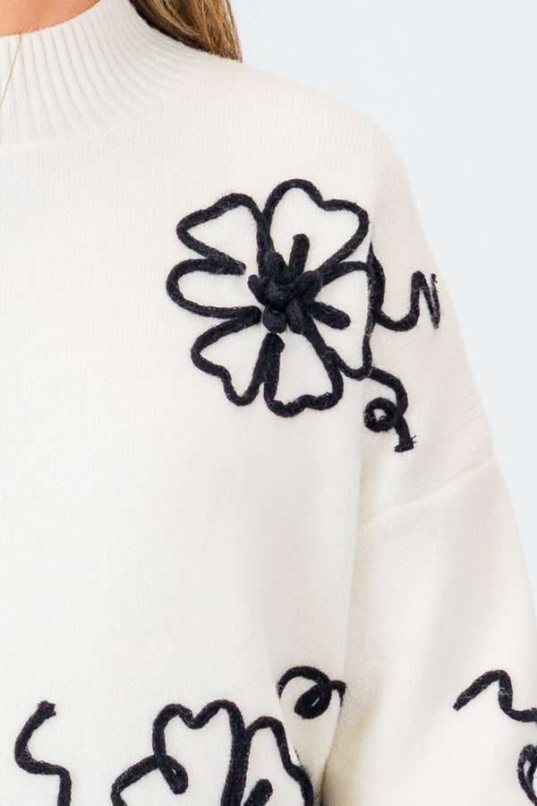 
Chic Soul plus size clothing, long sleeve cream sweater with mock neckline and cuff sleeves with textured black floral design