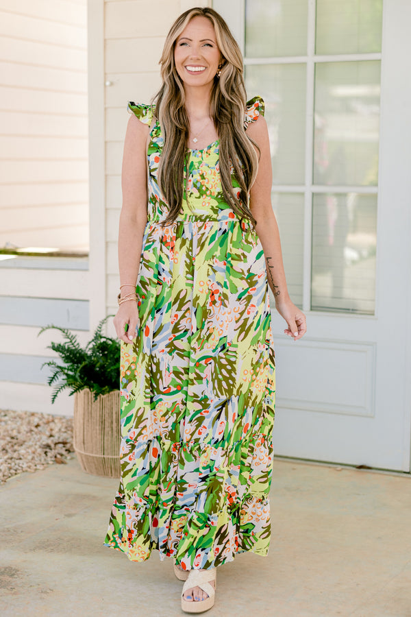 Chic Soul plus size clothing, sleeveless flutter strap green flowy wide-leg jumpsuit with a sweetheart neckline and a green multi-colored abstract tropical floral pattern 