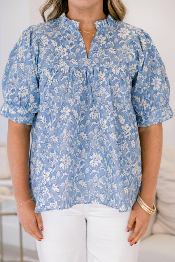 Plus Size blue floral cotton top with short puff sleeves, a ruffled neckline, and a relaxed fit.