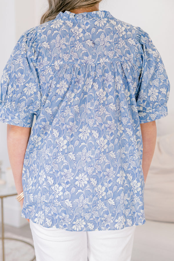 Plus Size blue floral cotton top with short puff sleeves, a ruffled neckline, and a relaxed fit.