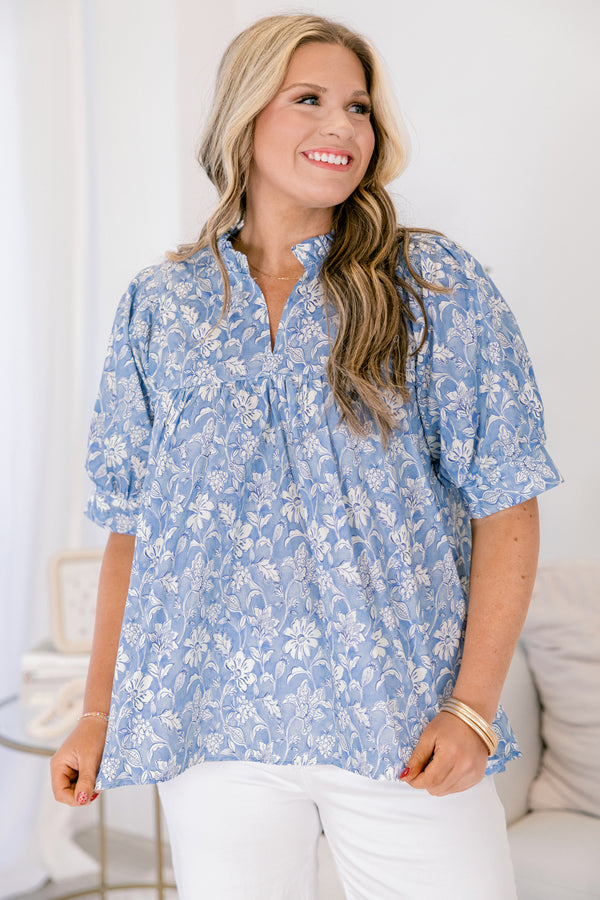 Plus Size blue floral cotton top with short puff sleeves, a ruffled neckline, and a relaxed fit.