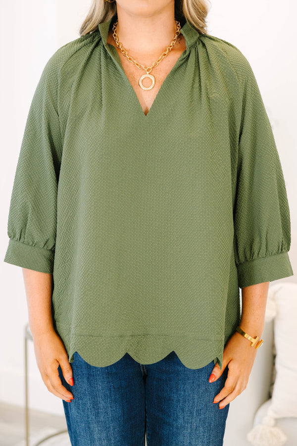Plus Size olive textured v-neck top with three-quarter puff sleeves and a scalloped hem.